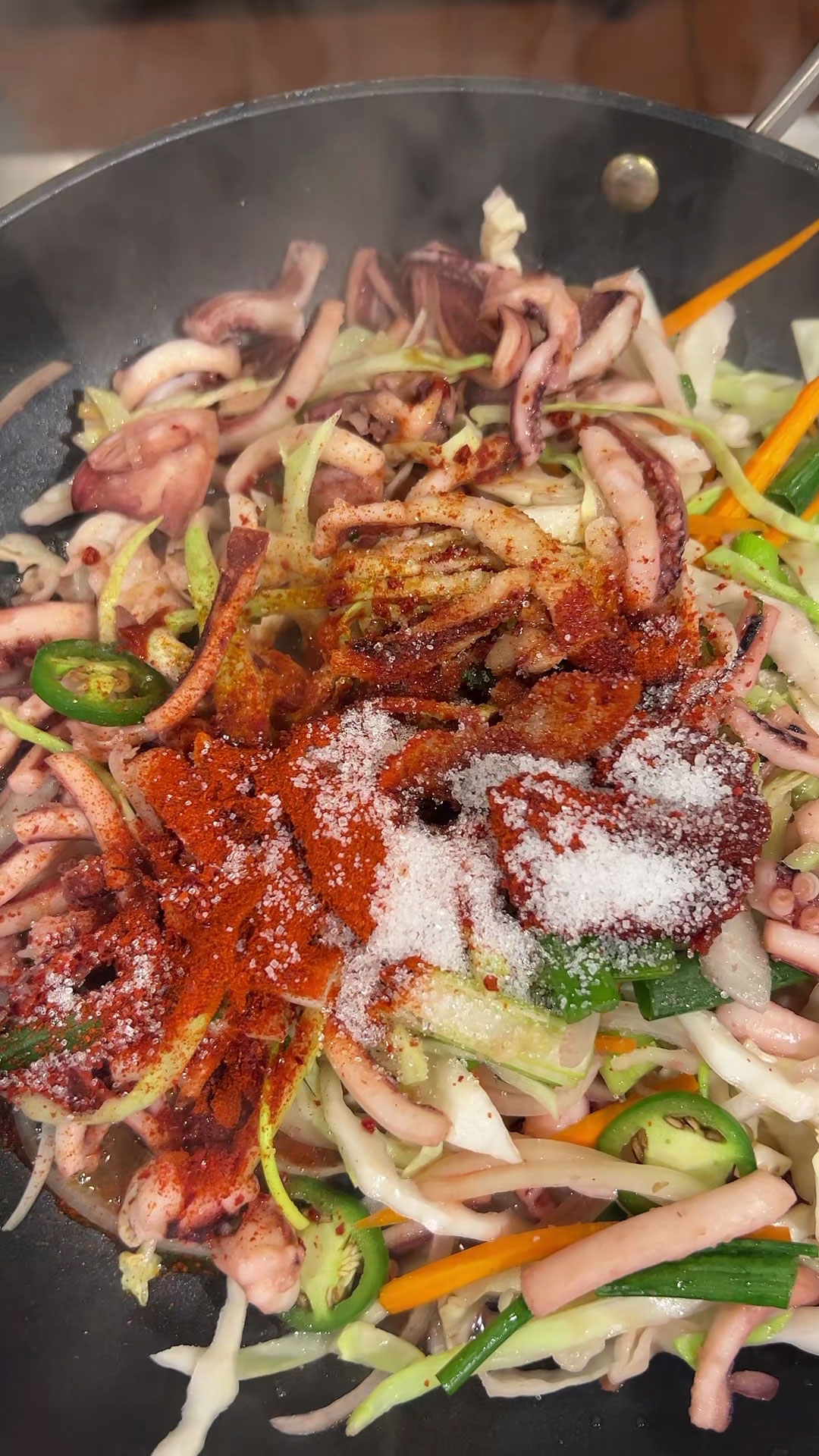 Season the squid with gochujang, gochugaru, soy sauce, sesame oil, plum extract, sugar, and sesame seeds 