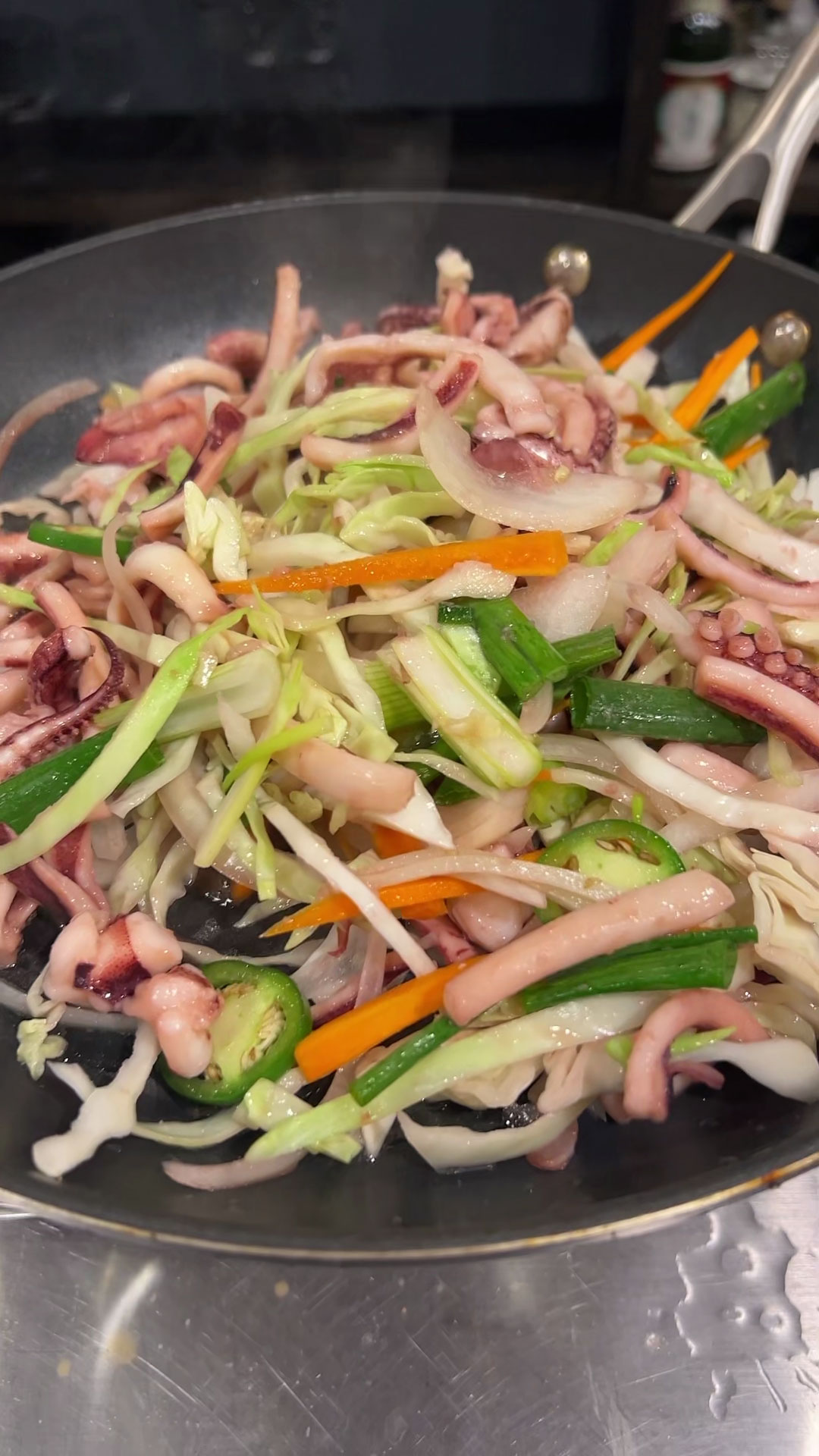 Add the vegetables and stir fry with squid 