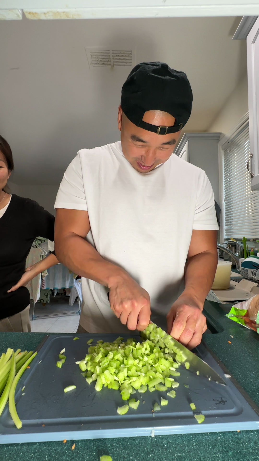 Chef Chris Cho mincing celery