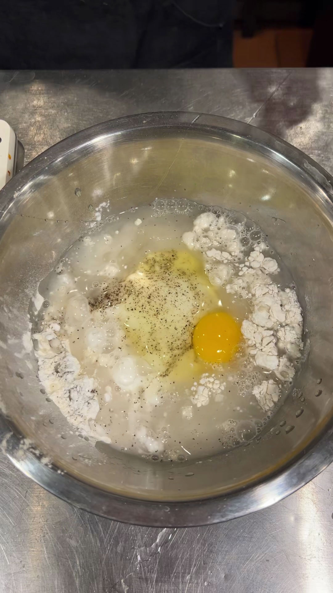 Combine flour, potato starch, salt, pepper, egg, and cold water