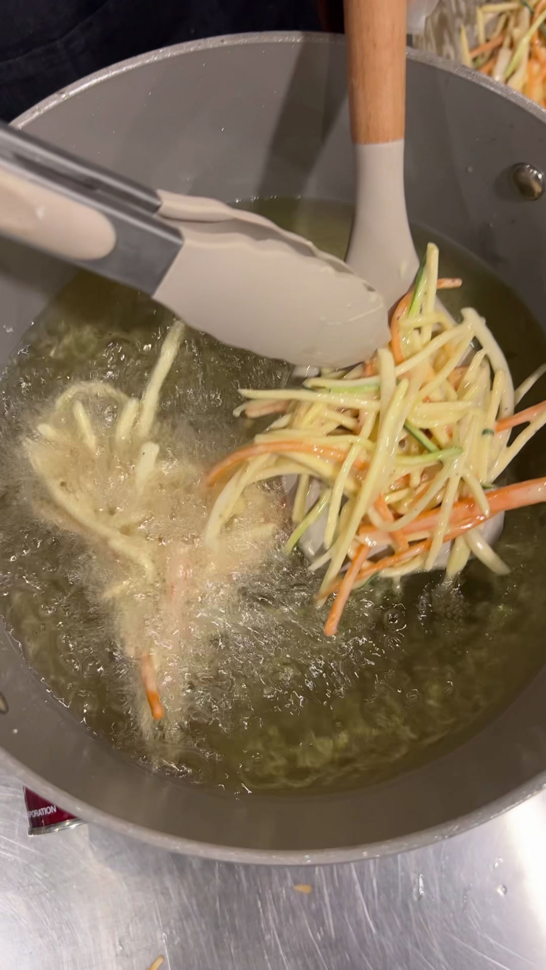 Lay the battered vegetables flat in a spatula and slide it into the fryer