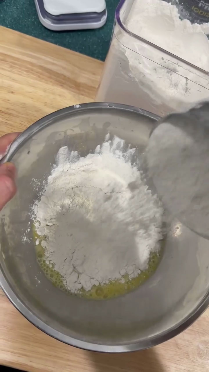 Combine the mixture of egg, milk, and salt with flour 