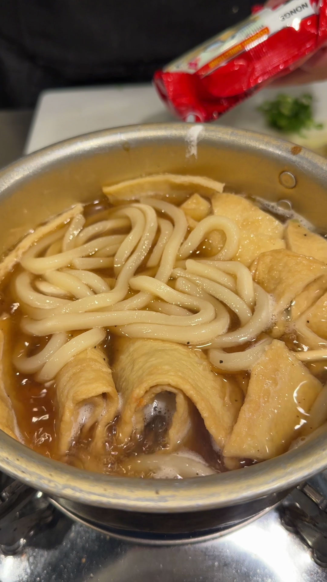 Add fishcake and enoki mushroom and let boil