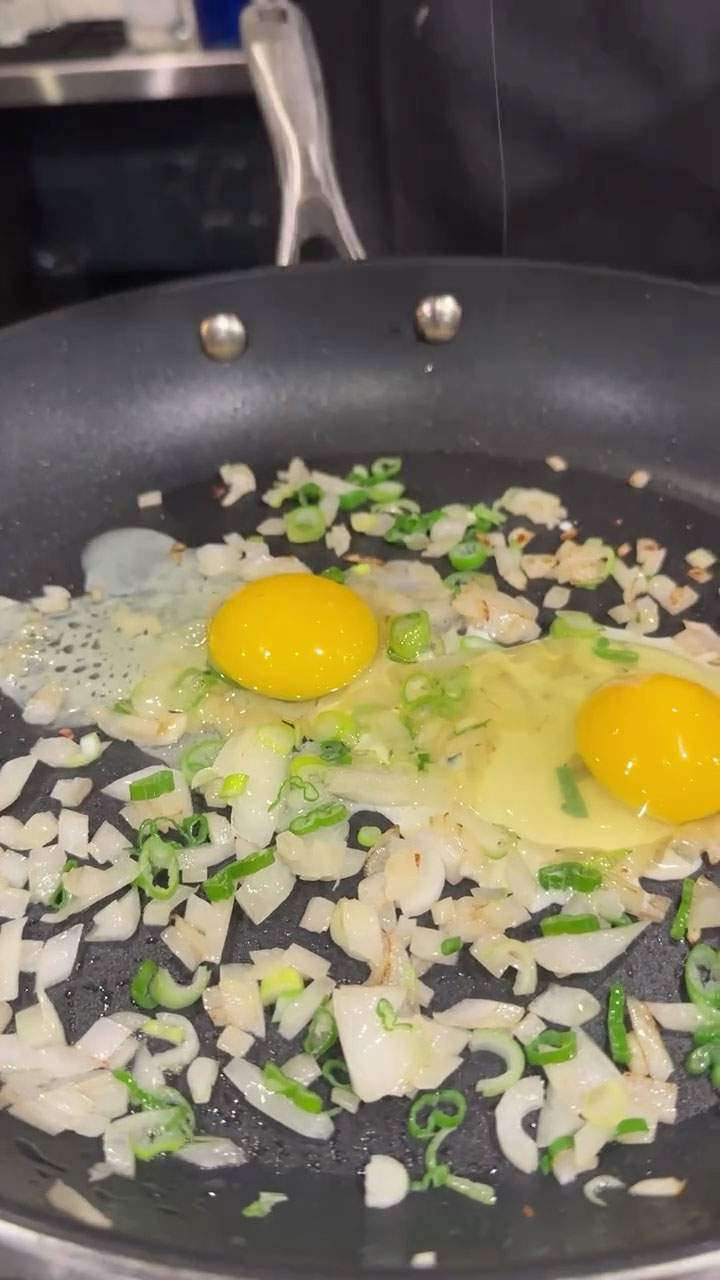 Place the eggs on top of the sauteed aromatics