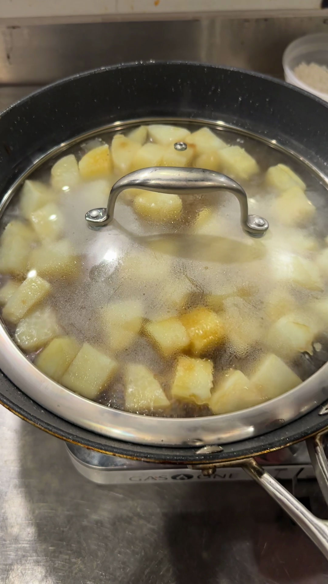 Cover the pan and braise the potatoes