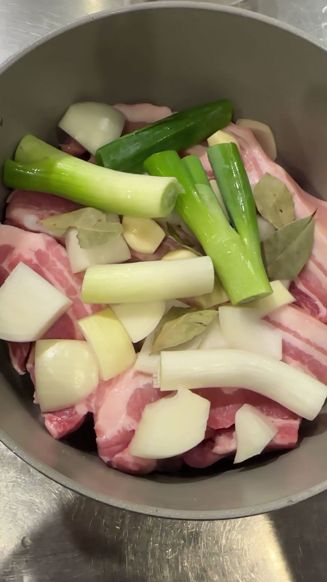 Place pork and aromatics in a pot