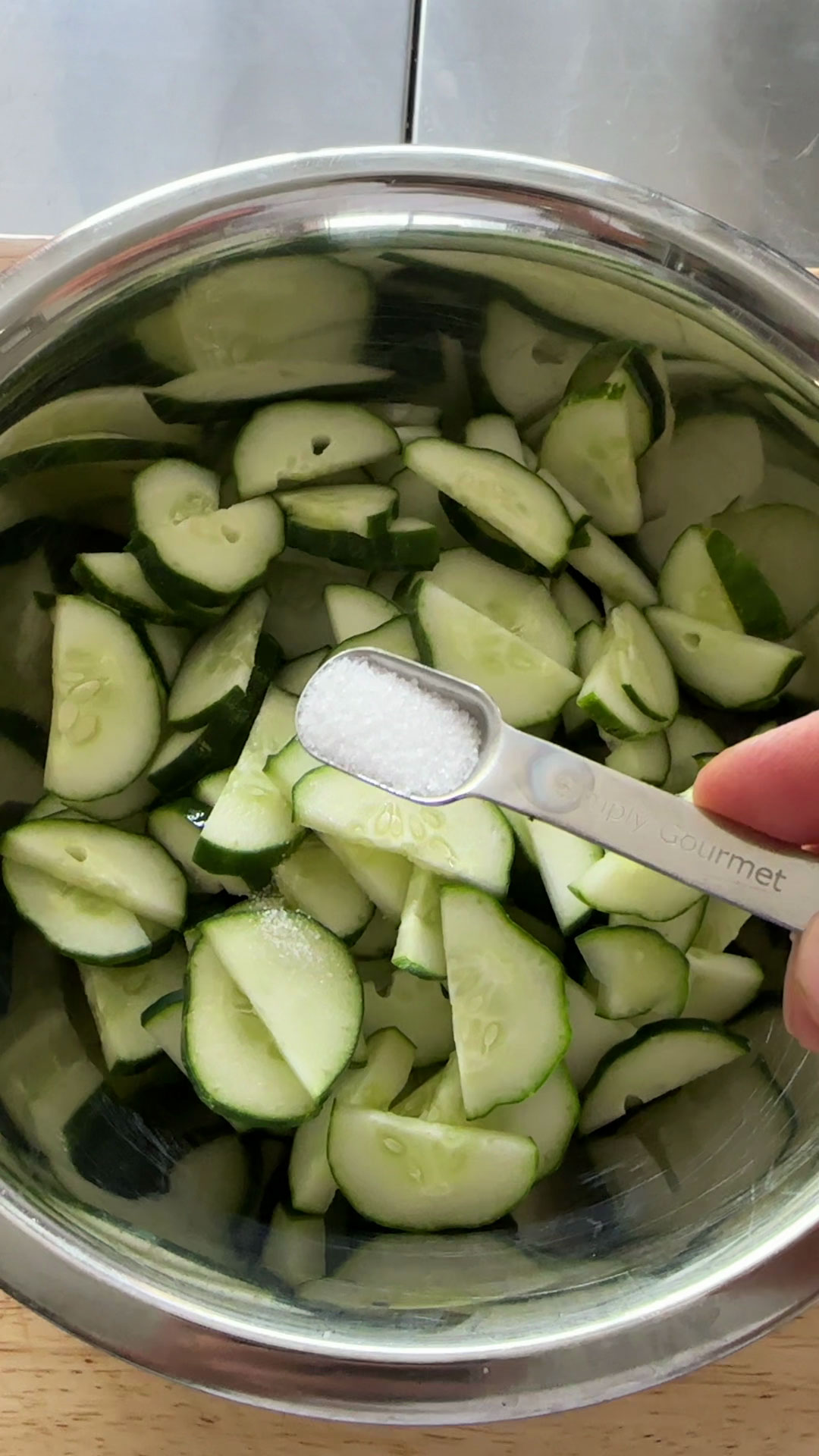 Add salt to the sliced cucumbers