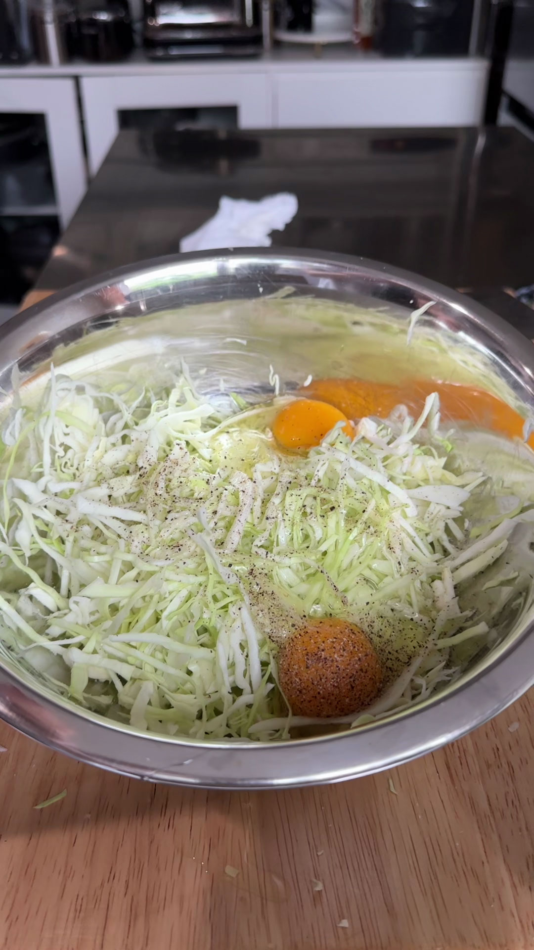 Combine cabbage, egg, salt, and pepper 