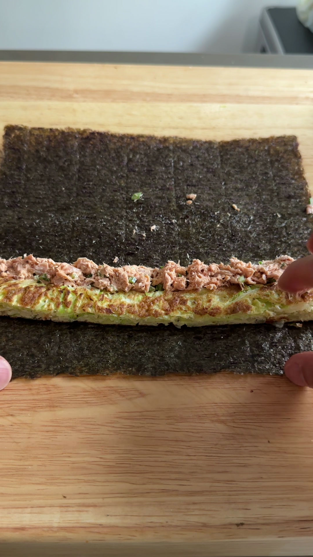 Place vegetable pancake and tuna-mayo 1-inch above the bottom of the seaweed 