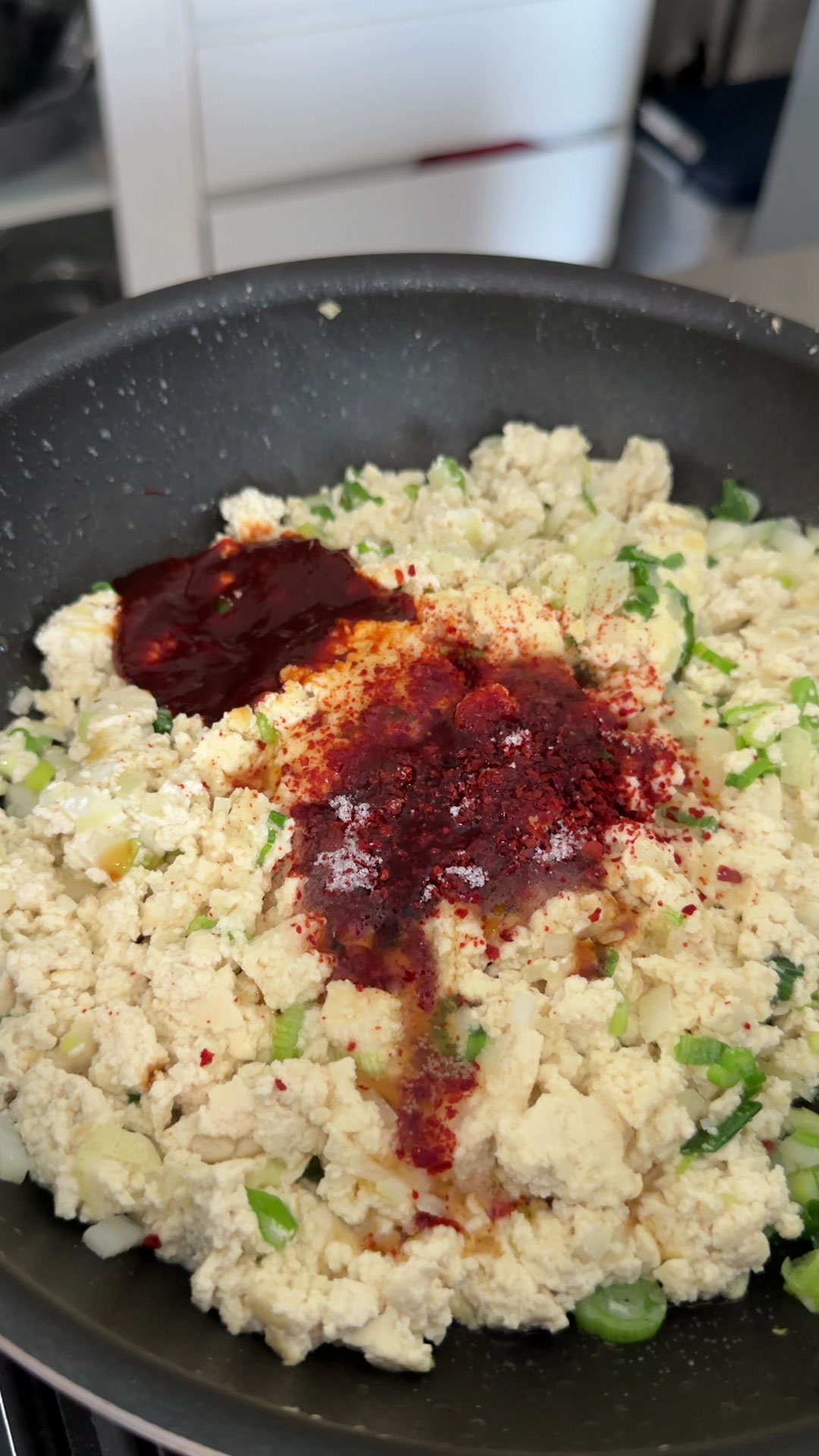 Season the tofu with gochujang, gochugaru, oyster sauce, sugar, and sesame oil 