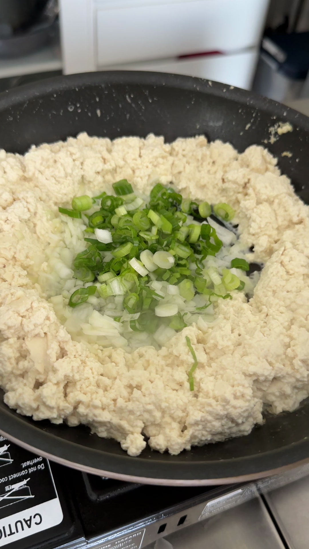 Make a well in the middle of the tofu and add the aromatics