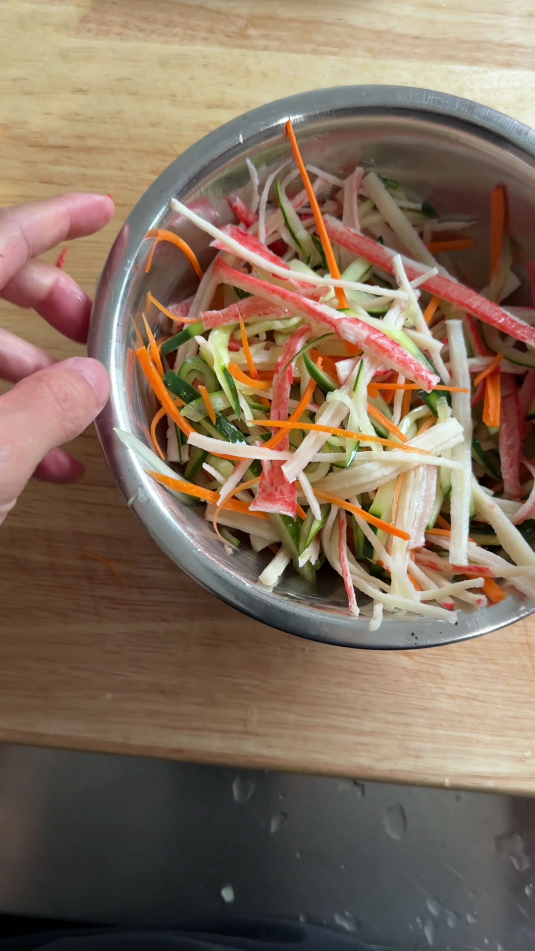 Combine the vegetables and imitation crab 