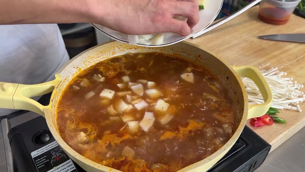 Add the onion and potatoes to the soup