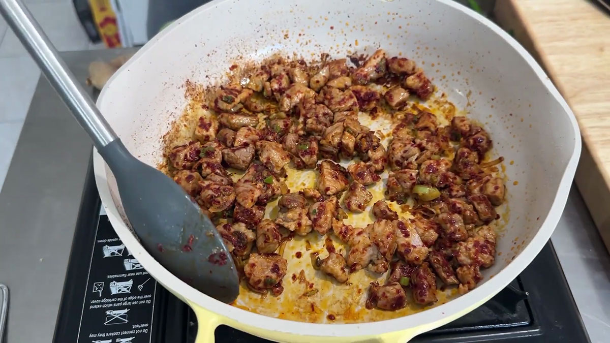 Season the pork and scallion mixture with soy sauce and gochugaru 