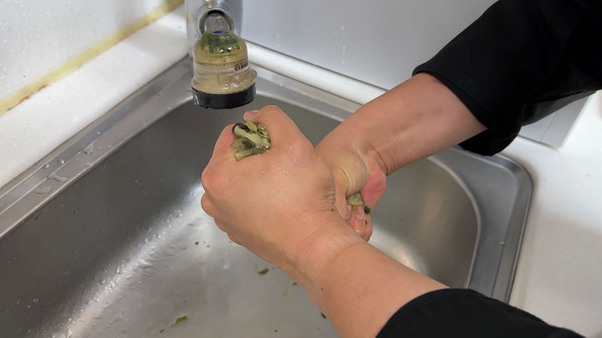 Squeeze out the excess water from the dried radish leaves 