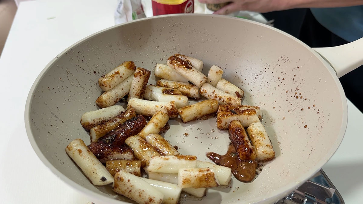 Season rice cakes with soy sauce, sugar, and garlic