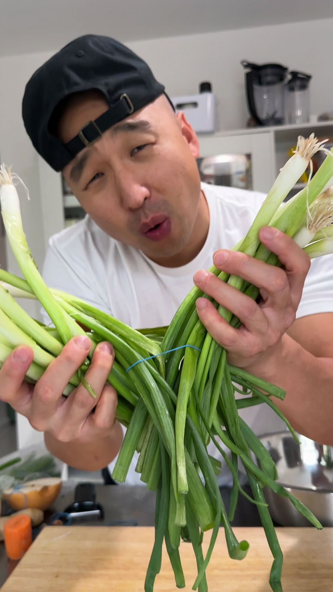 Chef Chris Cho bulk prepping garlic, scallions, and ginger 