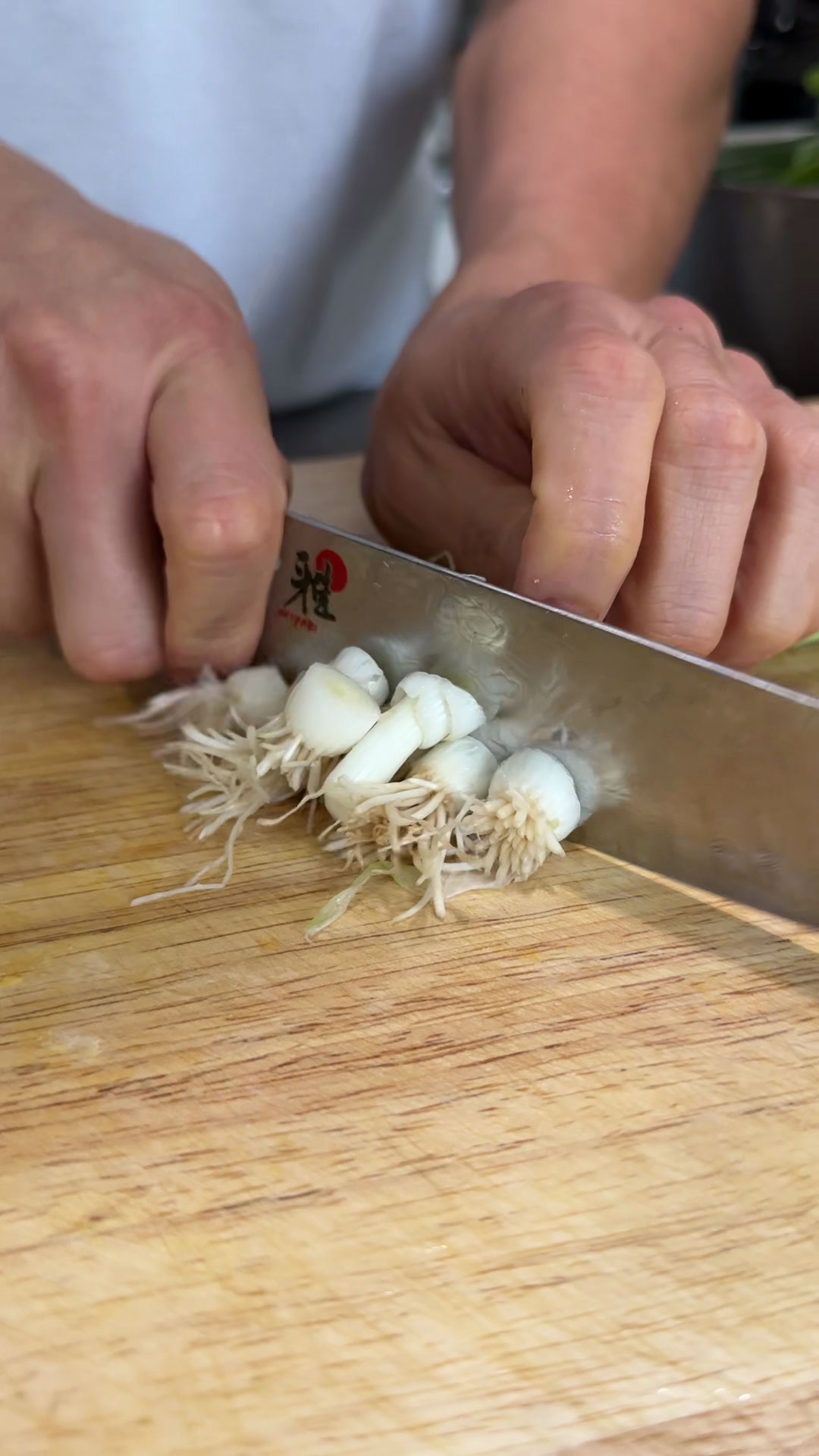 Trim off root from scallions