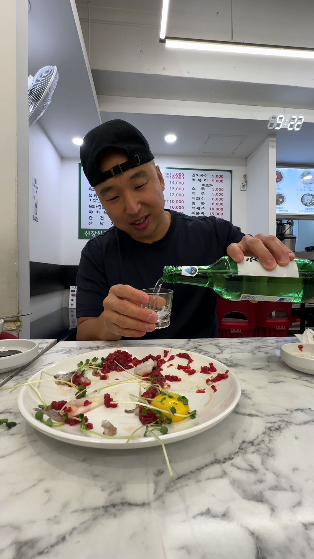 Drinking soju as accompaniment to yukhoe 