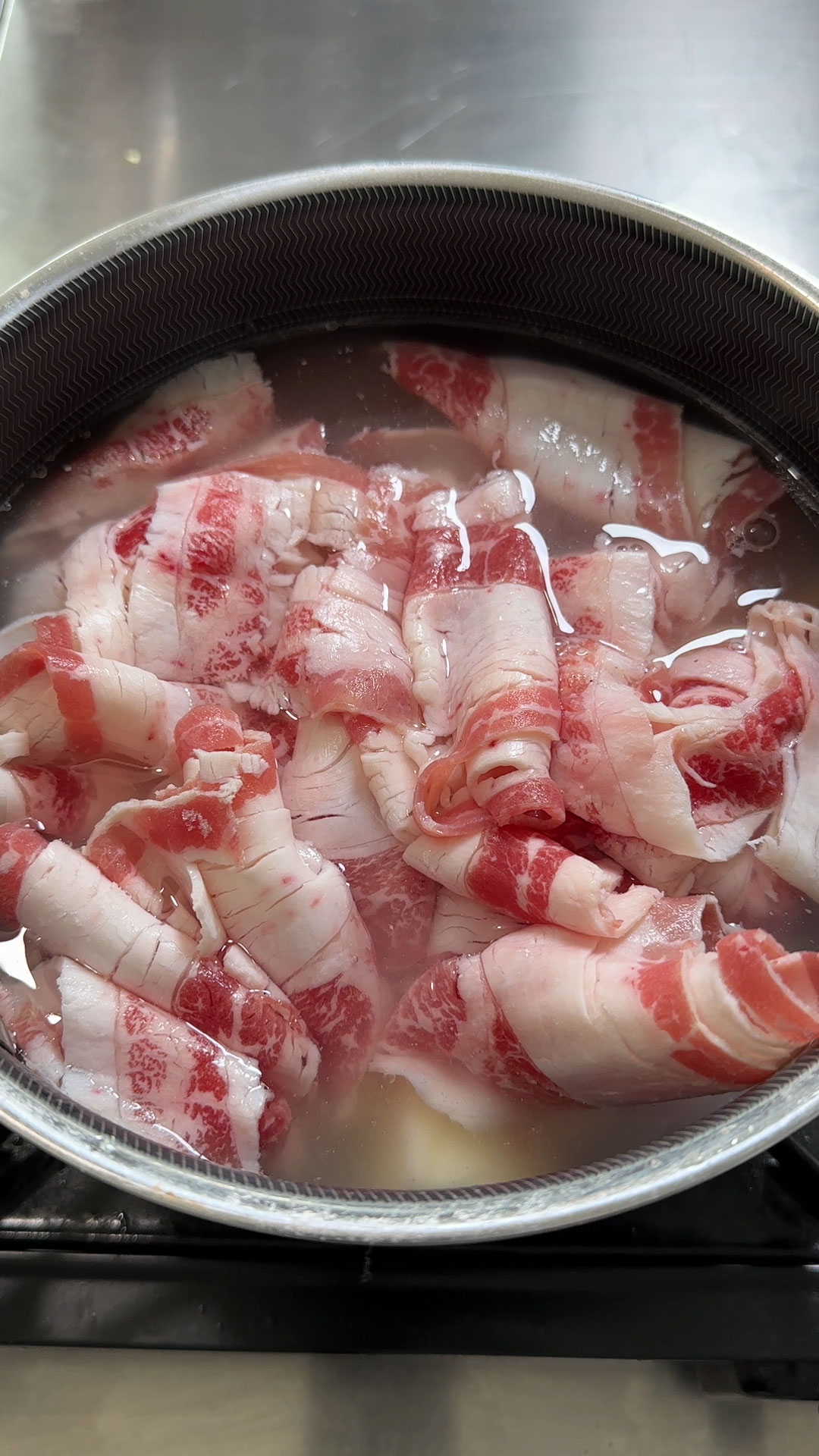 Combined together potatoes, sliced beef, water, and bone broth in a pot 
