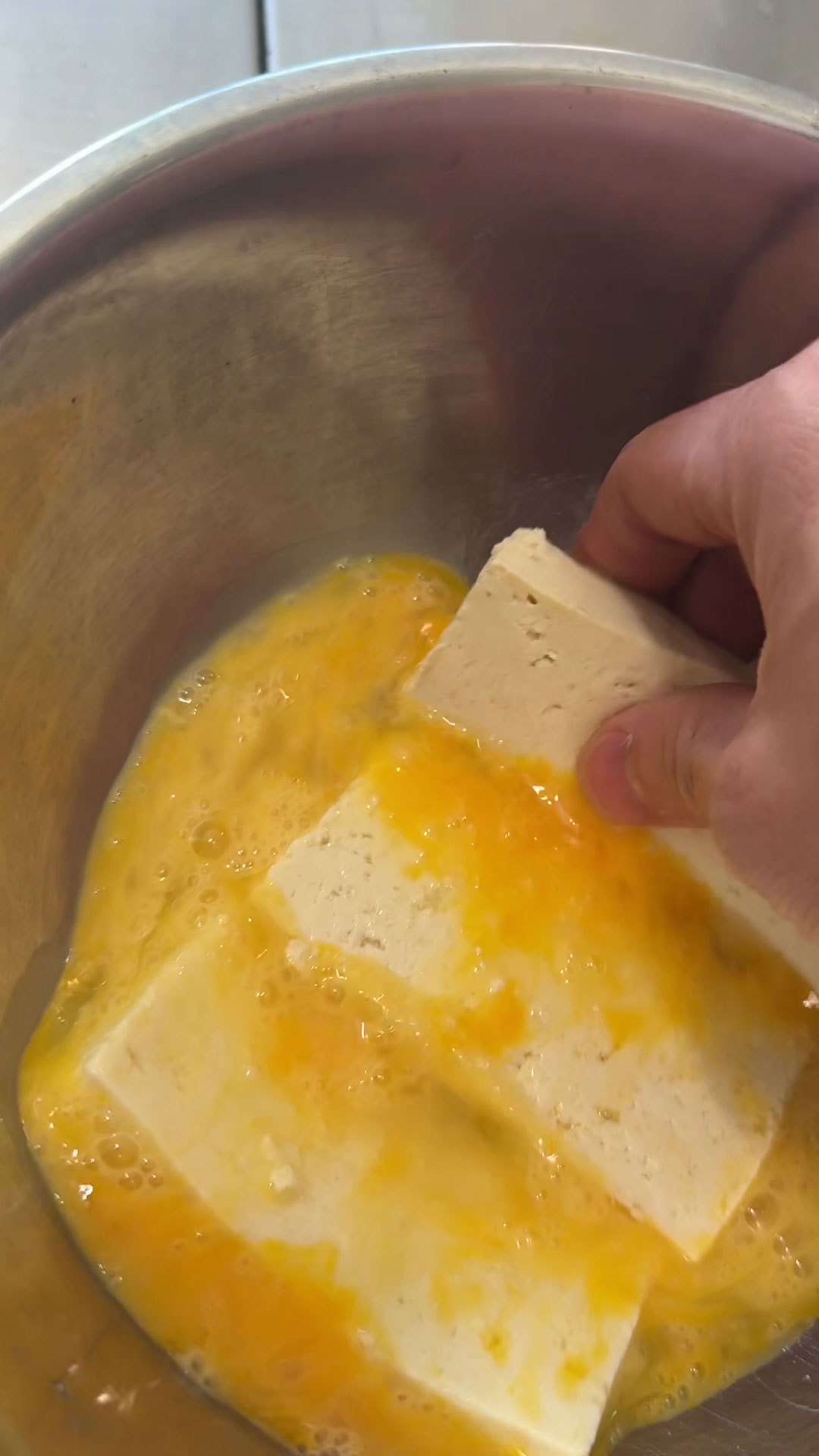Beat eggs and coat the tofu with it 