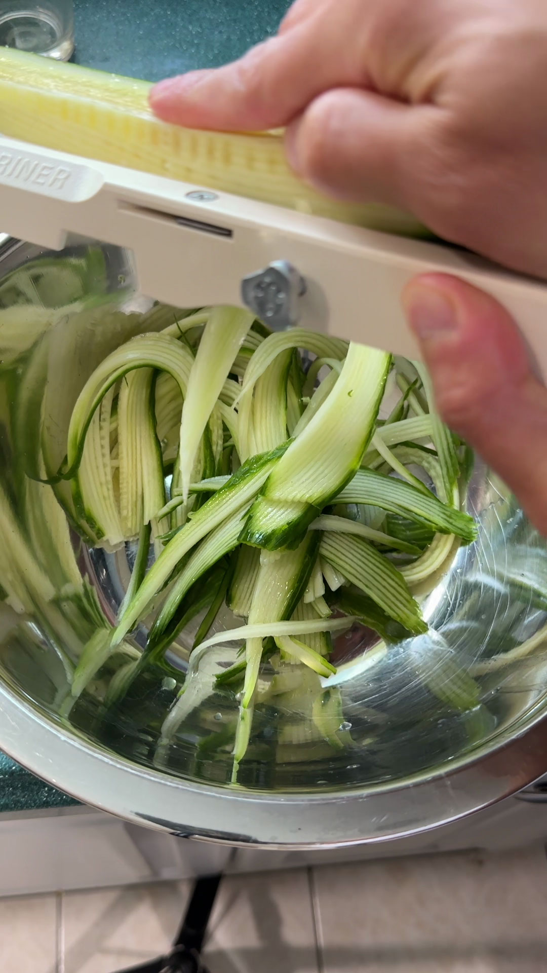 Slice the cucumber using a mandolin