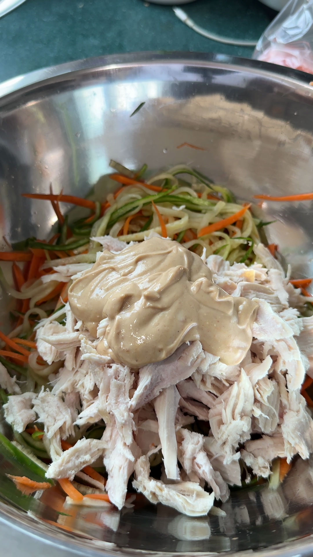 Combined veggies, shredded chicken, and peanut sauce