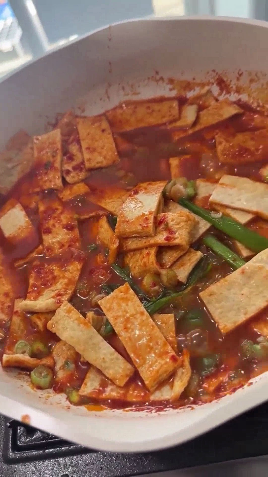 Add fishcakes and scallions into the tteokbokki sauce 
