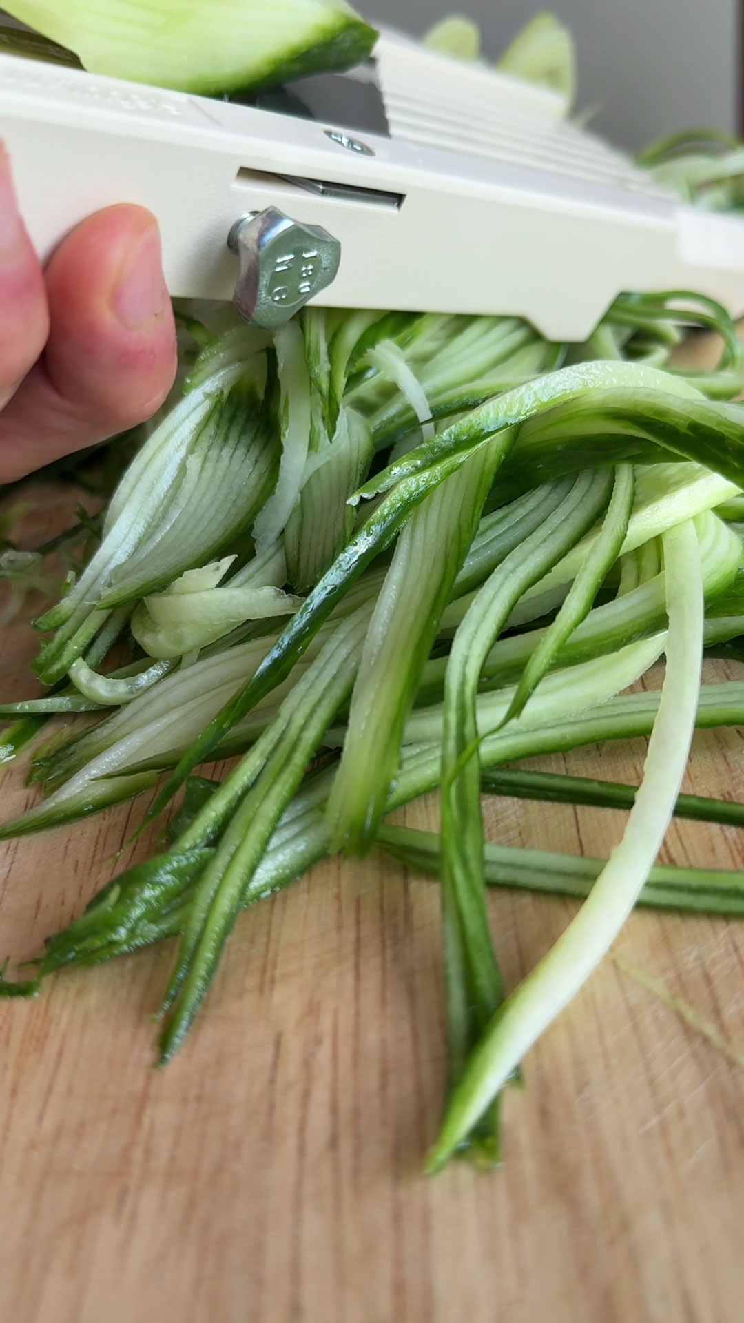 Slice the cucumber with a mandolin