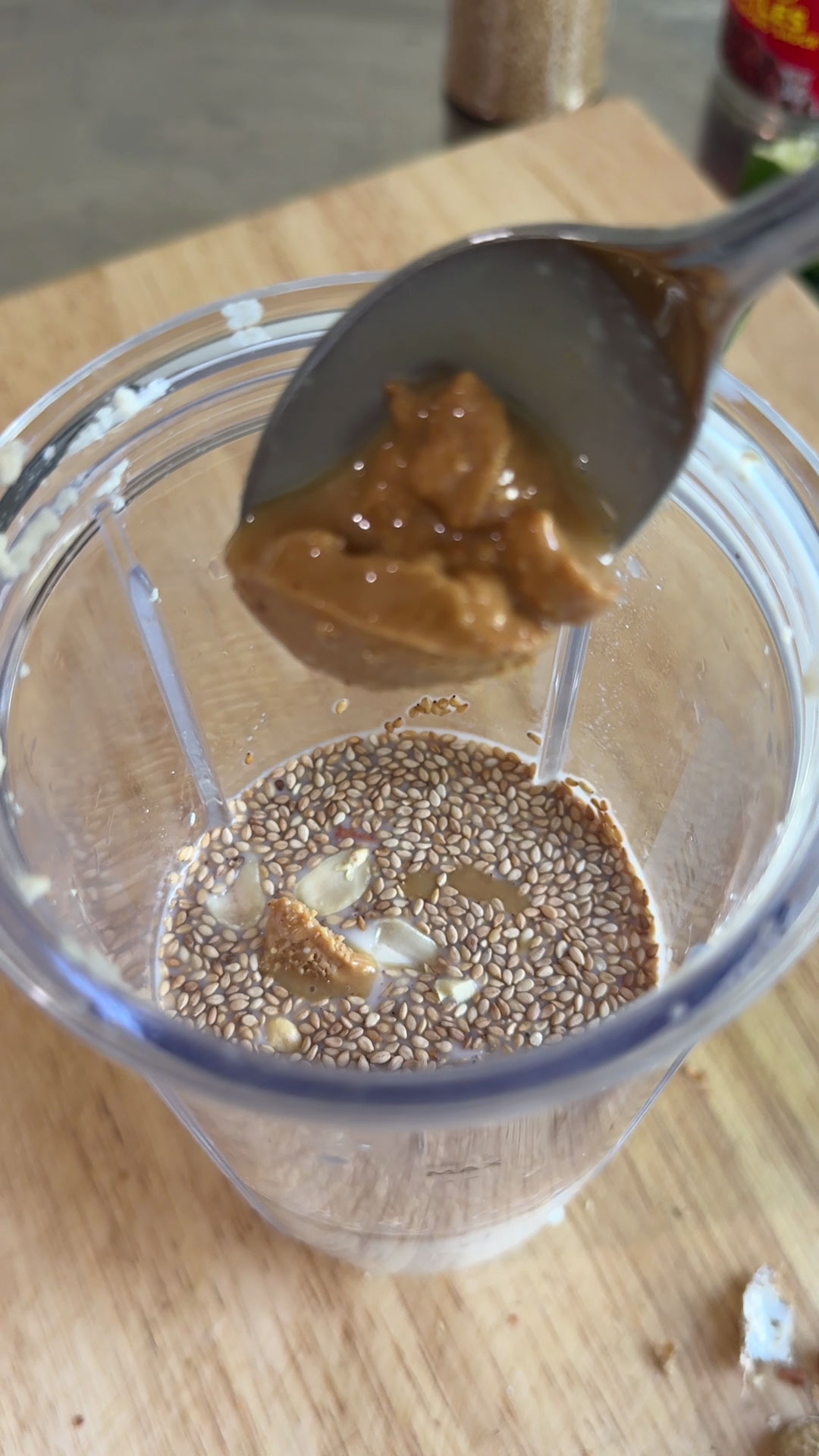Combine tofu, milk, water, roasted peanuts, roasted sesame seeds, allulose, and salt
