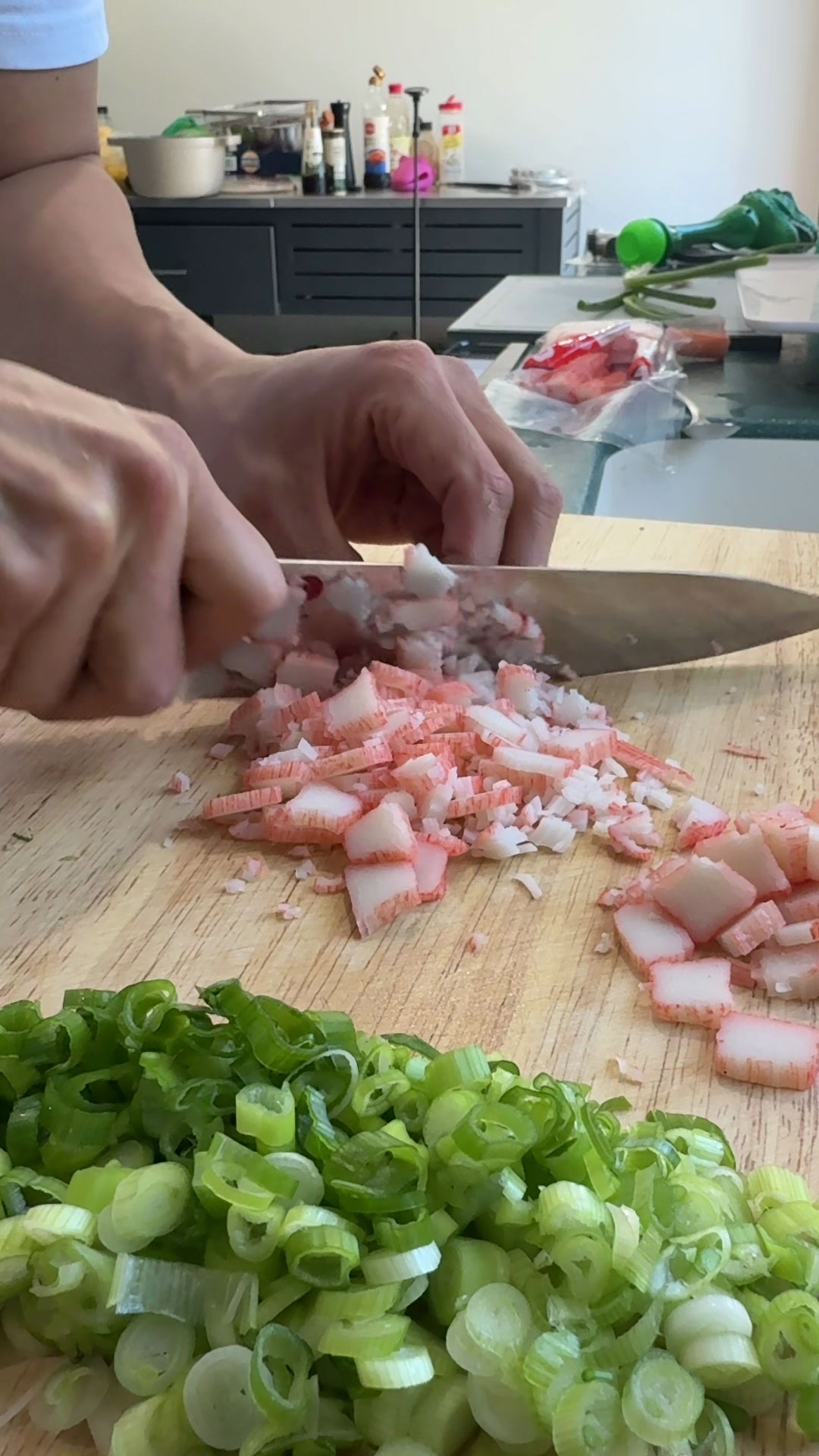 Chopping scallions and imitation crab