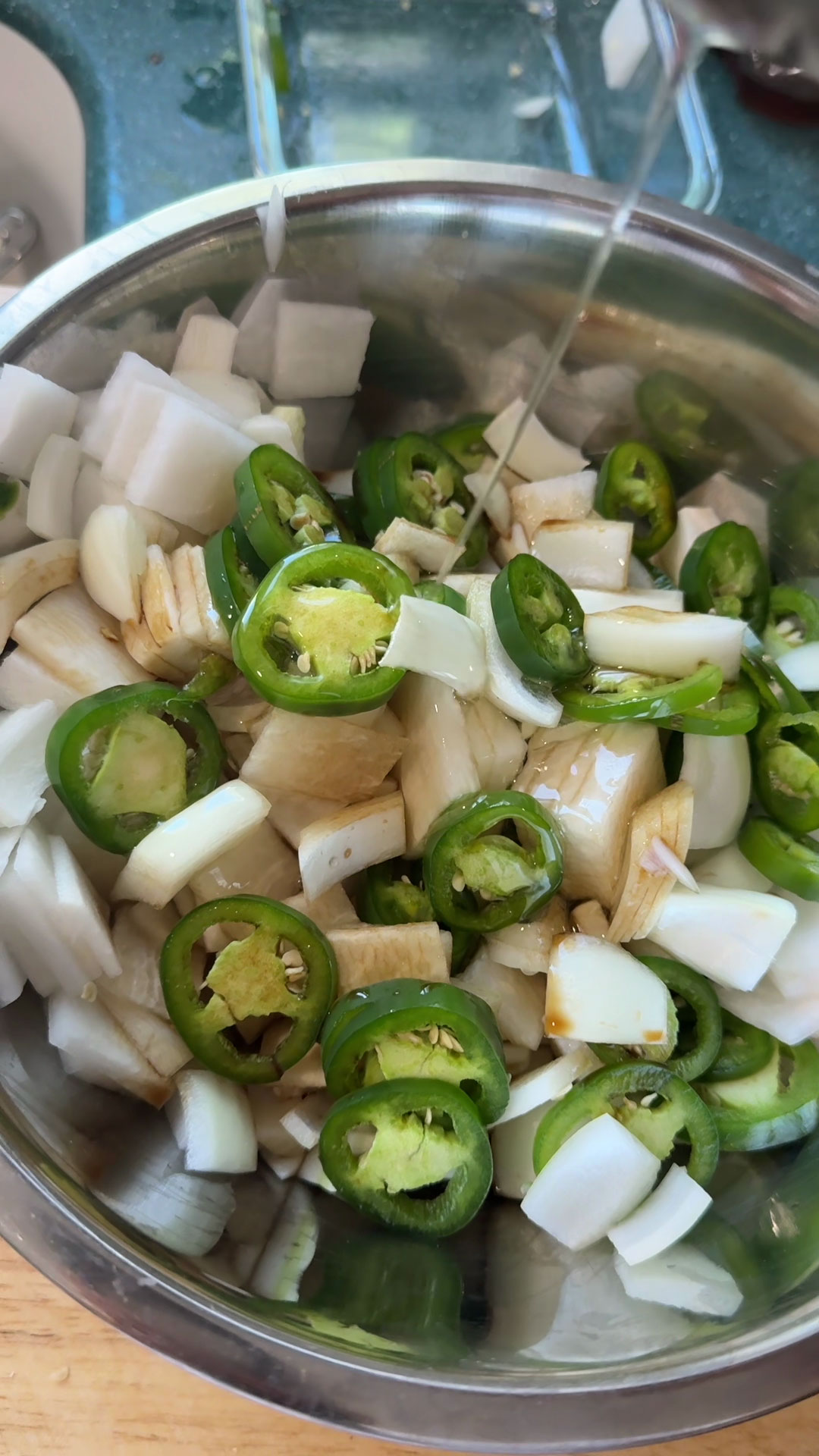 Place radish, peppers, and onion in a bowl then add soy sauce, vinegar, sweetener, and water 